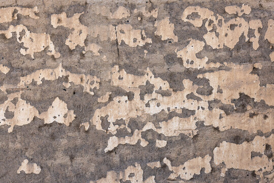 Close-up of Weathered Concrete Wall with Peeling Plaster Texture