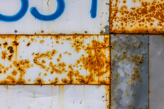 Textured Metal Surface with Rust and Blue Spray Paint