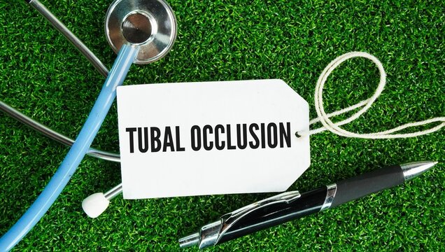 Stethoscope, pen and paper tag with the word Tubal occlusion are occurs when one or both fallopian tubes are narrowed or sealed, preventing an egg and sperm from meeting or blocking the passage 