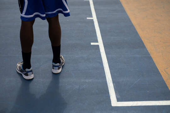 Basketball player standing in basketball court