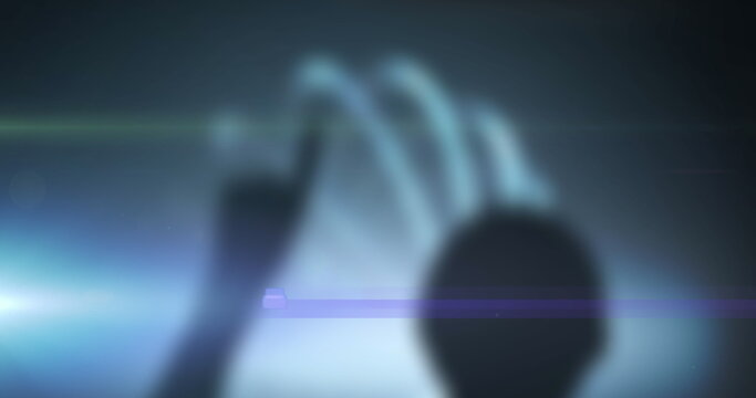 Silhouette of person touching futuristic digital interface with glowing effects