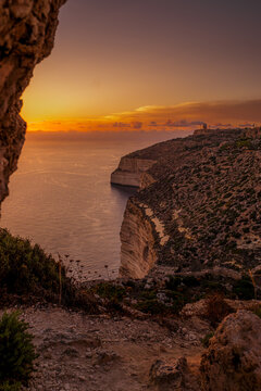 Sunset Landscape View over Coastal Cliffs in Dingli Cliffs Framed by Foreground Natural Cave Rock Formation during Golden Hour, Malta