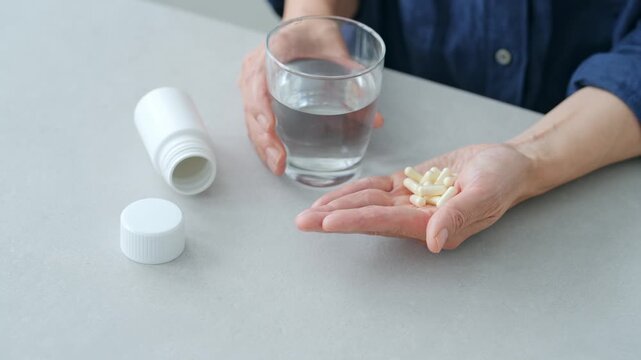 A woman trying to take a large amount of medicine
