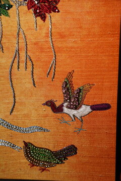 Ornamental bird motif in contemporary Indian folk art on textured canvas