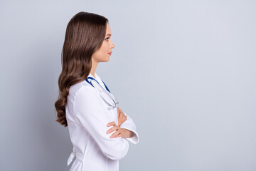 Profile portrait of successful calm person folded hands look empty space isolated on grey color background © deagreez