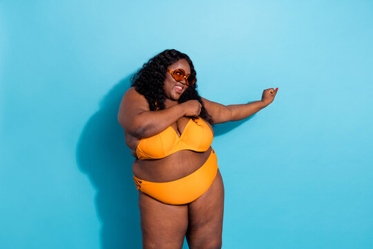 Photo of funky carefree lady cellulite curvy figure enjoy tourism no filters isolated on blue color background