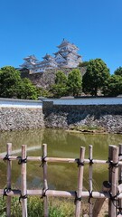 Historic Japanese castle architecture situated on a rugged landscape © k.cii