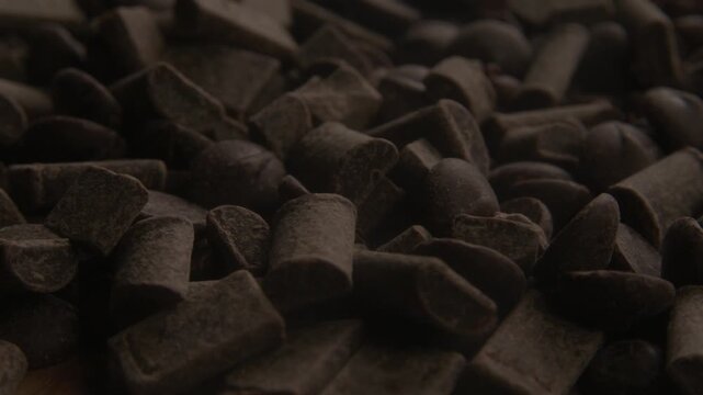 Dark chocolate chunks texture background close-up