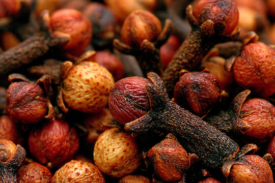 Macro view of aromatic dried clove buds piled together as a culinary spice with rack