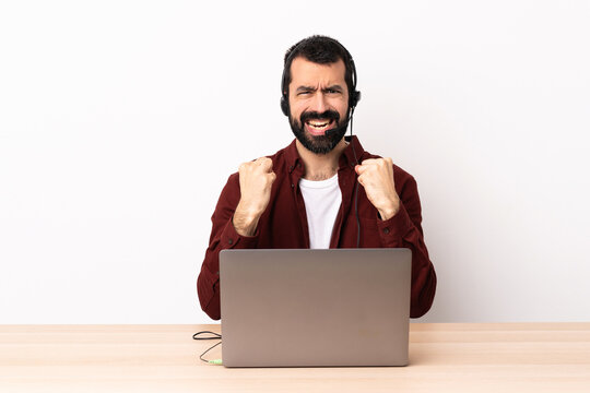 Telemarketer caucasian man working with a headset and with laptop frustrated by a bad situation.