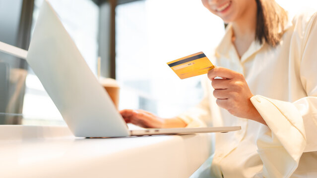 Asian woman using credit card using banking online payment digital technology currency wealthy financial