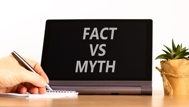 Fact vs versus myth words symbol. Concept words Fact vs Myth on beautiful black tablet. Beautiful white background. Businessman hand. Business and fact vs versus myth concept. Copy space.