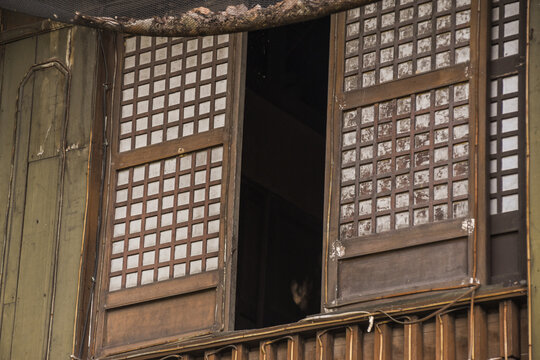 Old traditional house window in the Philippines made of wood and Capiz shells. Spanish era windows.