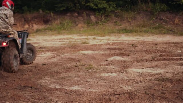 dusty road, offroad energy, dirt motion. Rider accelerates on rough outdoor path, kicking up soil while taking sharp corner.