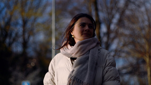 Caucasian woman breathing fresh air with wind in her hair, freedom, inner peace and stress relief