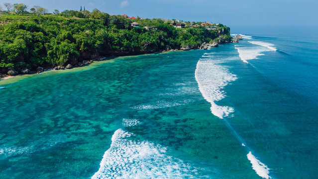 Tropical landscape with green cliff and turquoise ocean in Bali