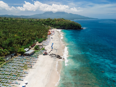 Virgin beach with white sand and blue ocean in Bali, paradise coastline