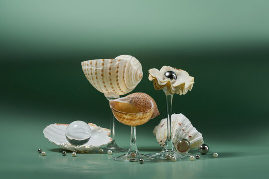 Seashells on glass stems with pearls, green backdrop