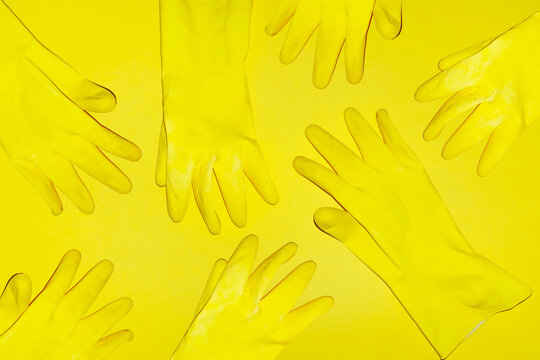 Yellow cleaning plastic rubber glove pattern on coloured background