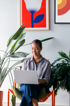 Woman Working Remotely on Laptop at Office