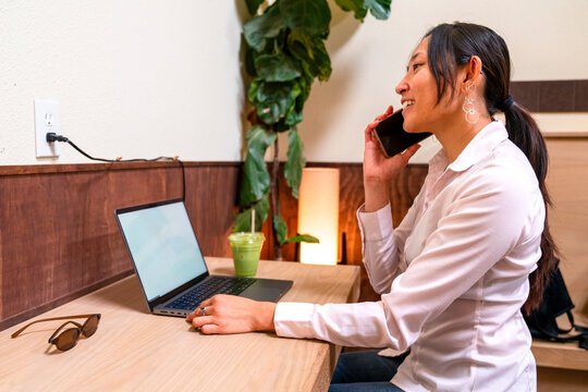 Working on a Laptop and Talking on the Phone in a Cozy Space