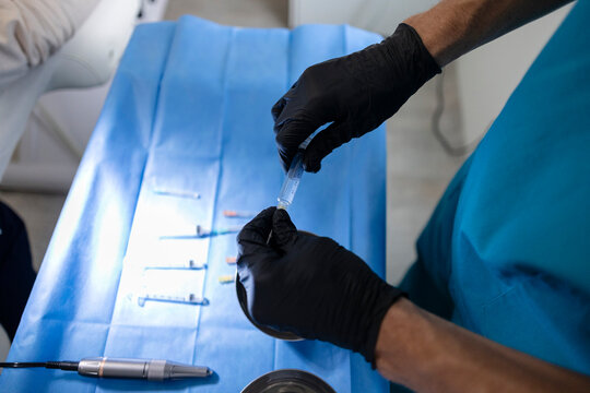 Professional preparing syringes for capillary injection procedure