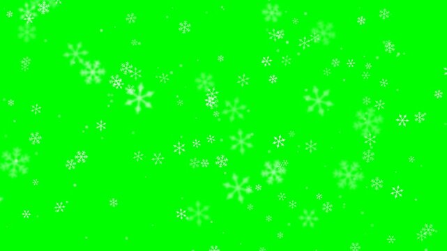 White snowflakes falling on a green screen background