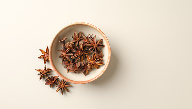 Star Anise Spices in Ceramic Bowl and Scattered Around on Light Surface