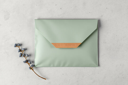 Biodegradable cornstarch mailer envelope flat lay on concrete surface