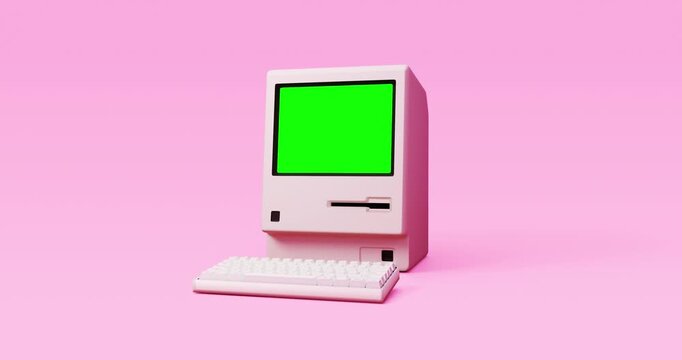 Vintage personal computer turning on revealing blank green screen in bright pastel pink background