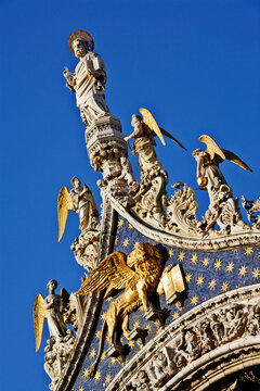 Statue of st. mark with angel sculptures and golden lion, italy