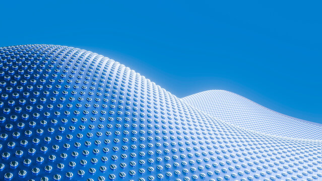 Curved reflective metal surface with round studs under blue sky