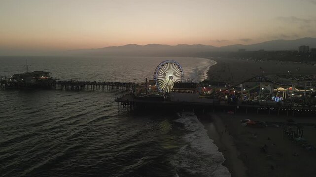 Aerial view of a pier and Ferris wheel at sunset in Santa Monica