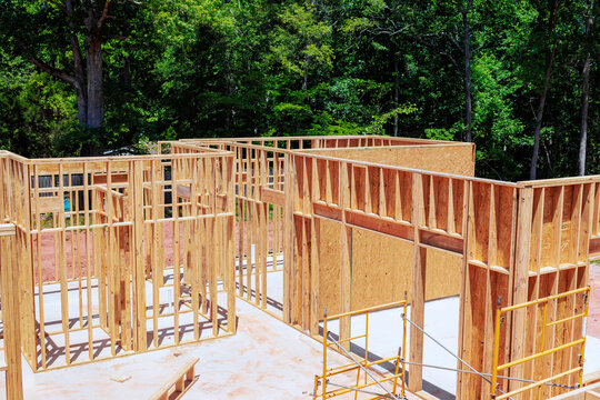 Workers build wooden beams frames for structure framing stage unfinished house