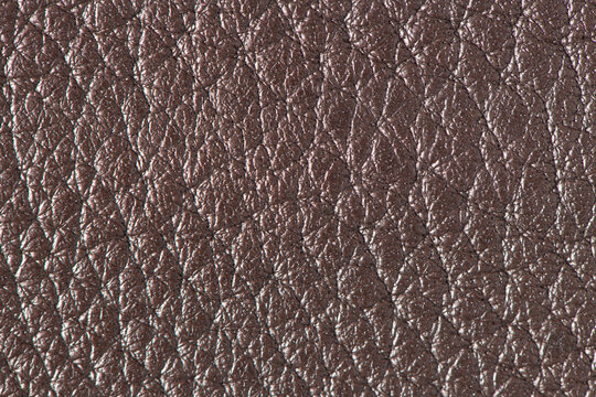 Close up of brown leather texture with natural grain pattern