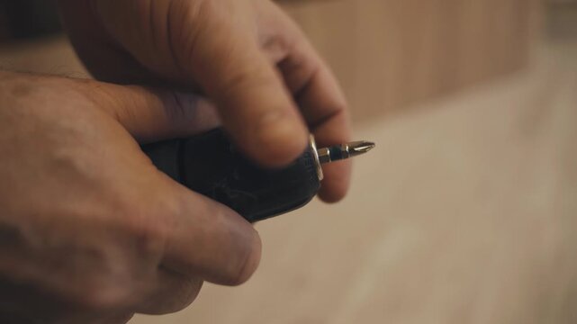 Hands demonstrate the effective use of a cordless screwdriver, showcasing techniques for changing bits and tightening screws in a well-lit workspace filled with wooden surfaces.