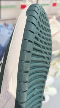 A close-up view showcases various sneaker designs with a focus on textures and details. The craftsmanship is highlighted as different styles are presented, revealing their unique features.