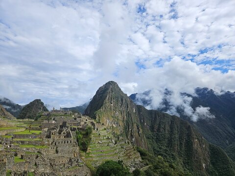 Breathtaking high-altitude view of the historic Inca citadel of Machu Picchu nestled in the Andes mountains of Peru.
