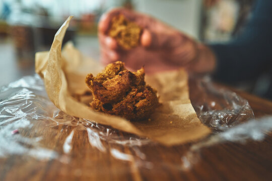 Close-Up of Crumbly Homemade Cake Pieces on Brown Paper