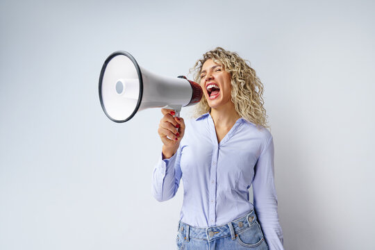 A woman with a megaphone. Promotion, action, ad, job questions, discussion. Vacancy. Business concept, communication, information, news, team media relations.