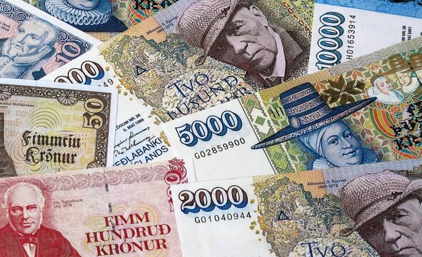 Big amount of Icelandic krona money banknotes. Iceland cash bills of ISK currency close up
