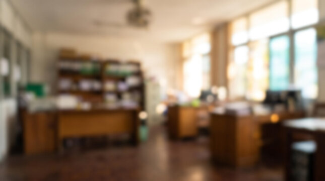 Blurred small Yangon office with wooden desks and ceiling fan, defocused background with copy space