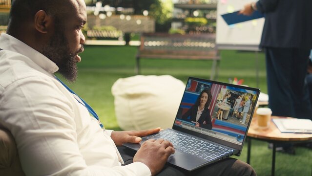 Businessman, laptop and online news as man watches presenter and video report on computer screen. Digital media, current affairs and connectivity support news access from outdoor terrace.