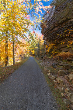 Upper Awosting carriage road  in Minnewaska State Park, NY, on a crisp and clear Autumn morning surrounded by vivid fall foliage