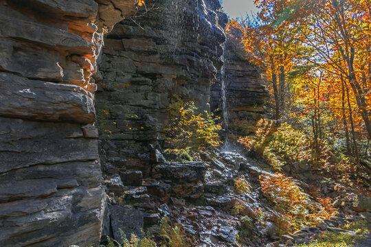Upper Awosting carriage road  in Minnewaska State Park, NY, on a crisp and clear Autumn morning surrounded by vivid fall foliage