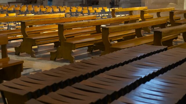 Empty benches aligning in a church: a symbol of hope. Wooden church benches progressively align, creating a visually appealing pattern within a sacred space, symbolizing order