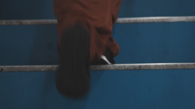 Close-Up of Feet Climbing Blue Stairs, Slow Motion