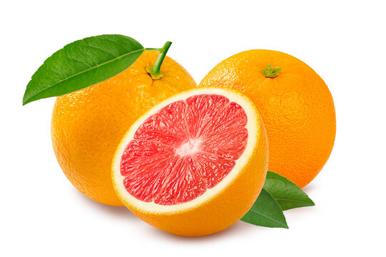 Group of ripe oranges with one cut in half to reveal juicy red flesh, featuring fesh green leaves.  fruit photography isolated on white background.