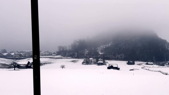Panoramic View over City of Thun with House and Bare Tree in a Foggy Winter Day with Snow in Thun, Bernese Oberland, Bern Canton, Switzerland
