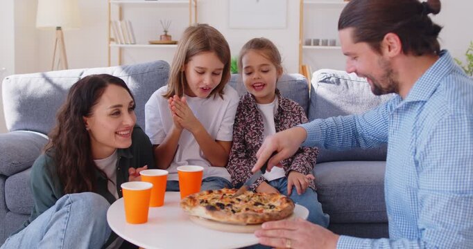 Father serving pizza for happy family, union gather meal at home, taking tasty pizza slices to enjoy, takeaway delivery service, enjoying weekend moment, leisure time, common holiday dinner together